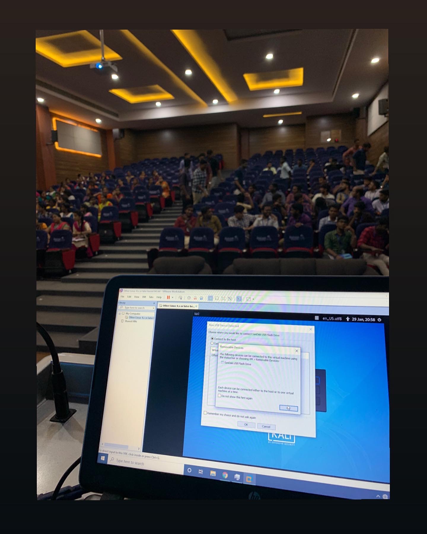 A live cybersecurity workshop being run in a packed college auditorium